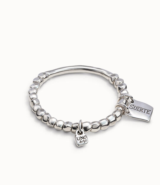 Beaded stretch bracelet with tubular piece and a charm